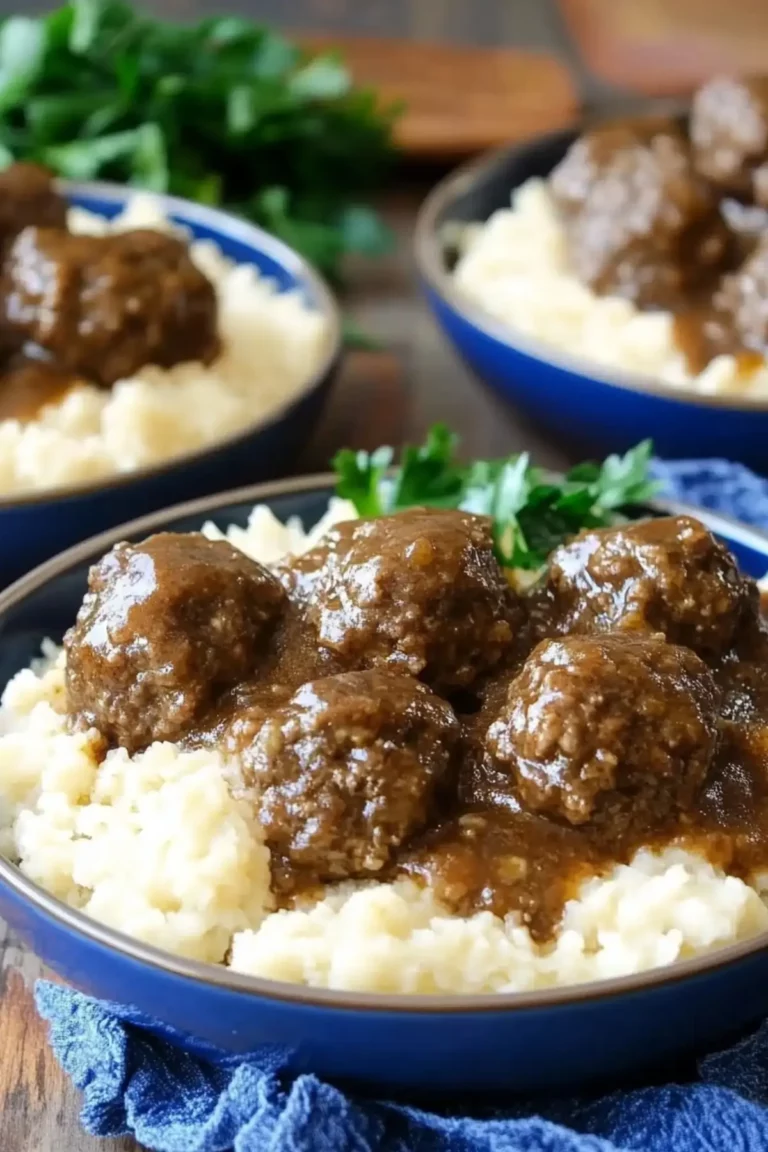 Slow Cooker Salisbury Steak Meatballs served over mashed potatoes