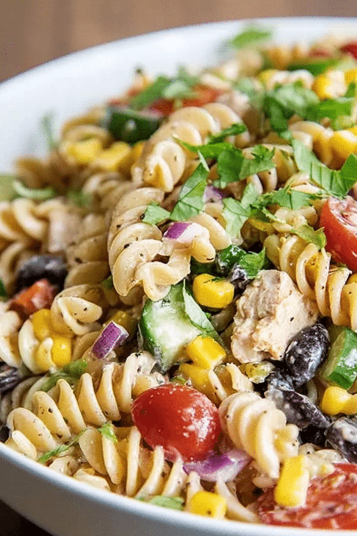 A colorful vegetable pasta salad with fresh vegetables, perfect for summer meals.