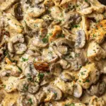 Creamy Chicken Stroganoff served over egg noodles with mushrooms and sauce