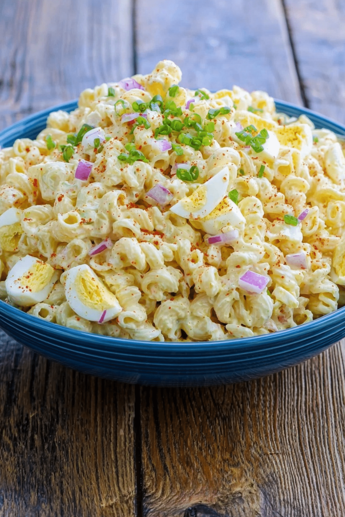 Deviled Egg Pasta Salad served in a bowl with paprika garnish