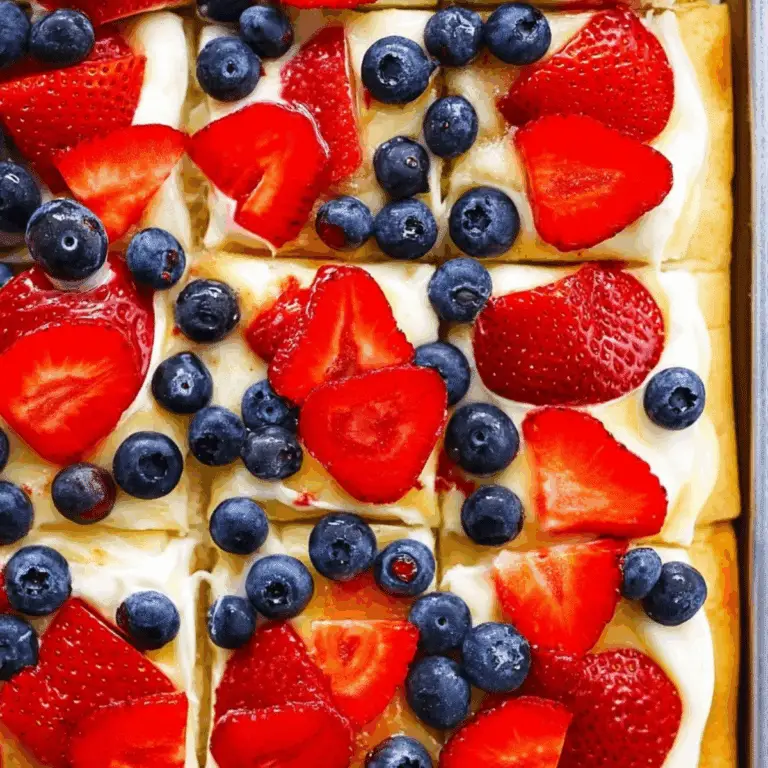 Fruit pizza with sugar cookie crust, cream cheese frosting, and fresh fruit toppings