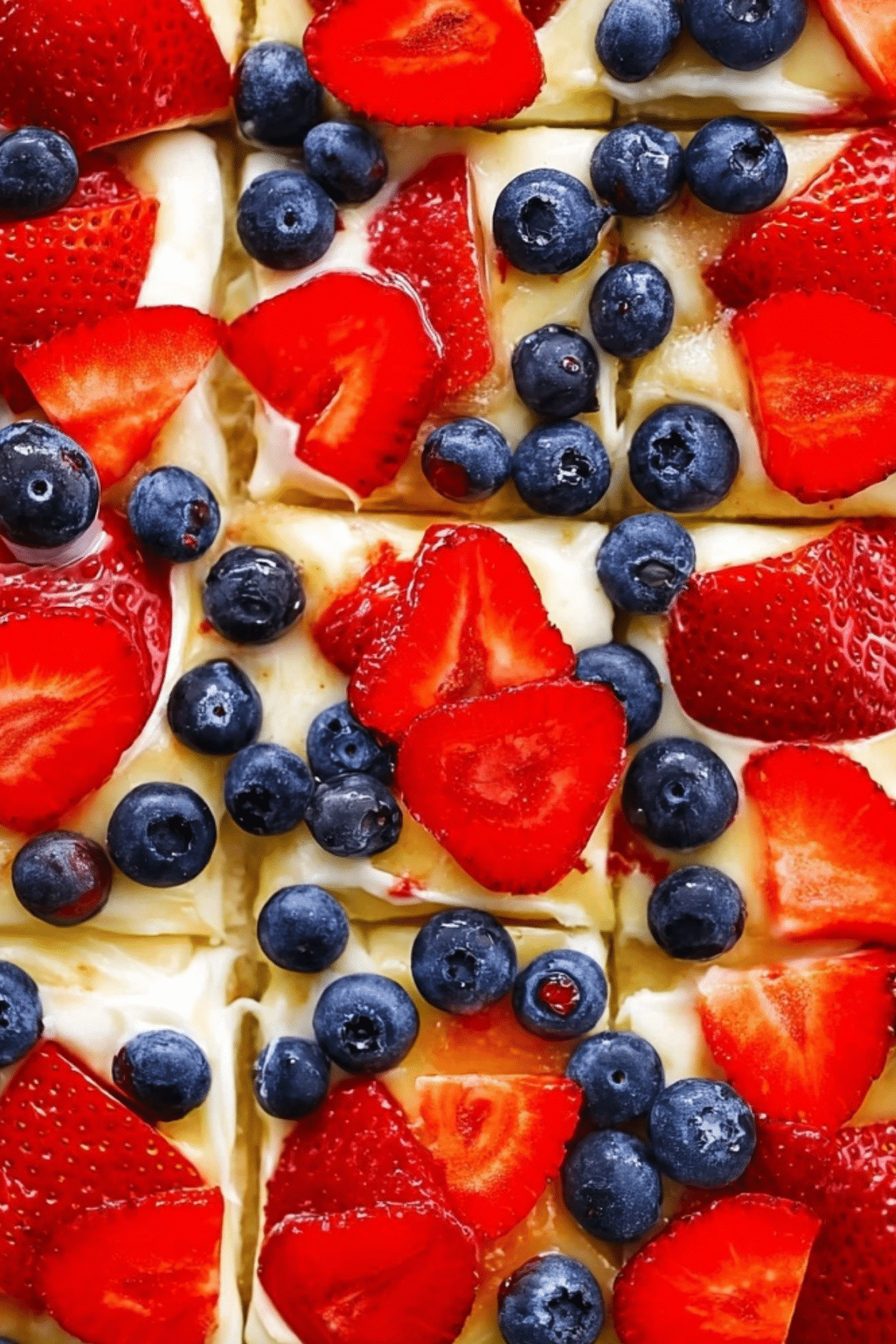 Fruit pizza with sugar cookie crust, cream cheese frosting, and fresh fruit toppings