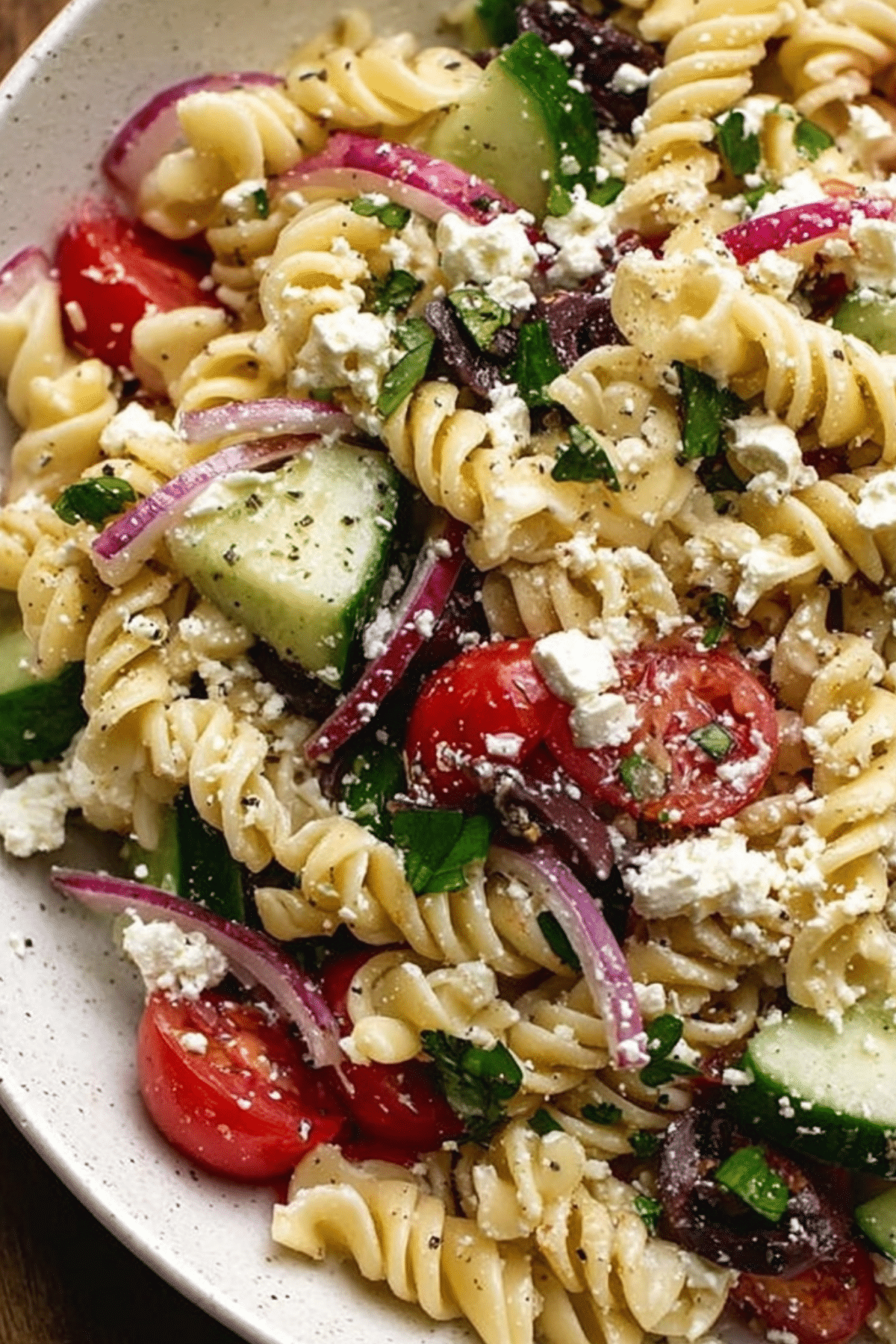 Greek Pasta Salad with fresh vegetables and feta in a bowl