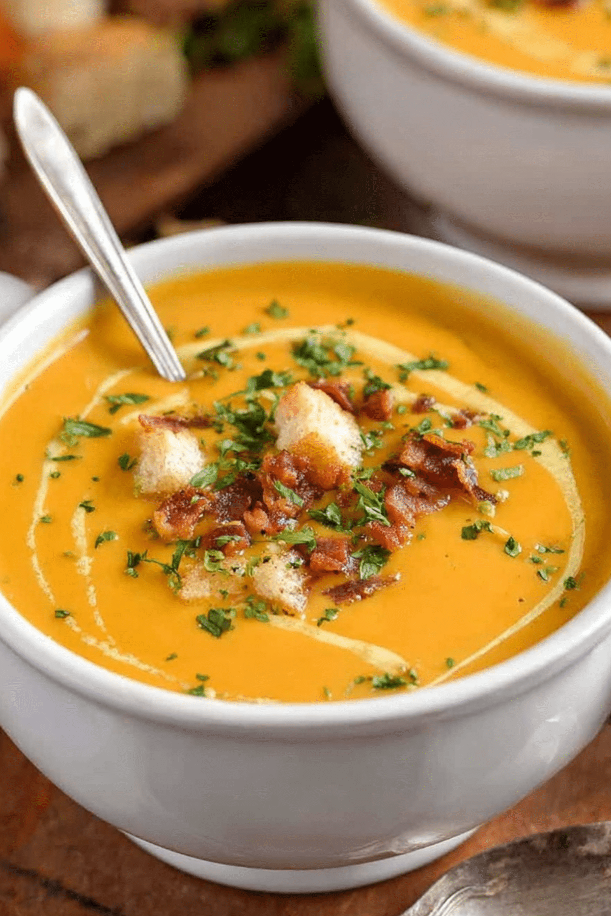 Pumpkin soup served in a bowl with bacon and cream, perfect fall comfort food