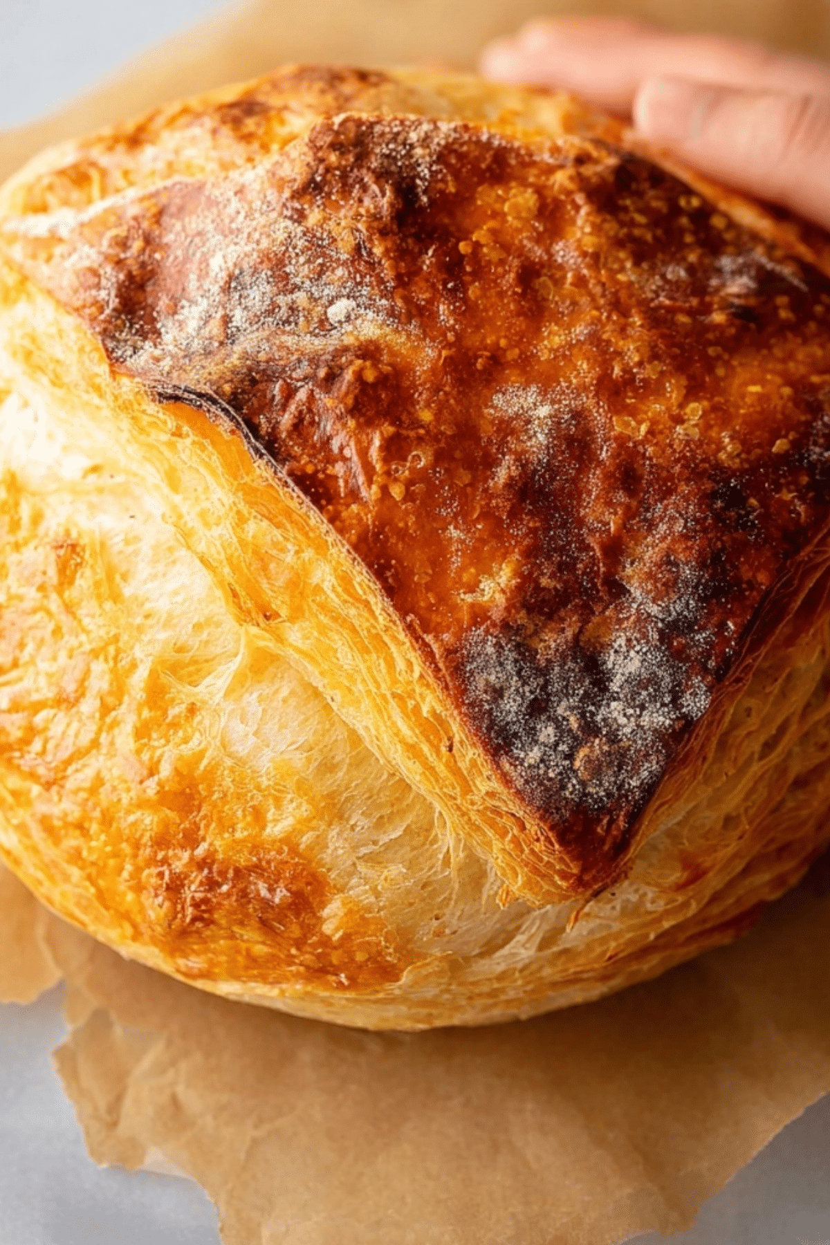 freshly baked sourdough croissant bread with flaky golden crust