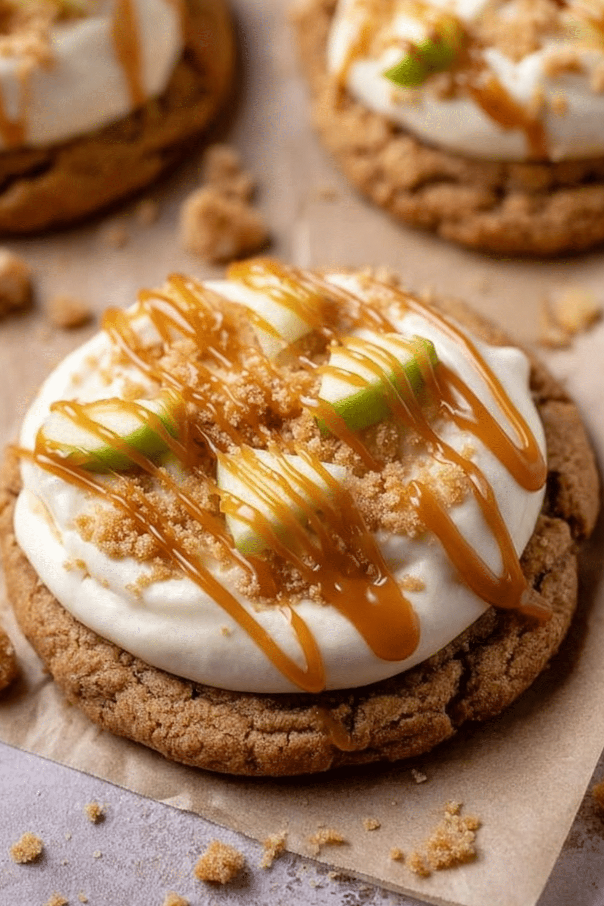 Caramel Crumbl Apple Cookies with caramel frosting and green apple chunks