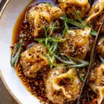 chili crisp butternut squash dumplings served in ginger soy broth