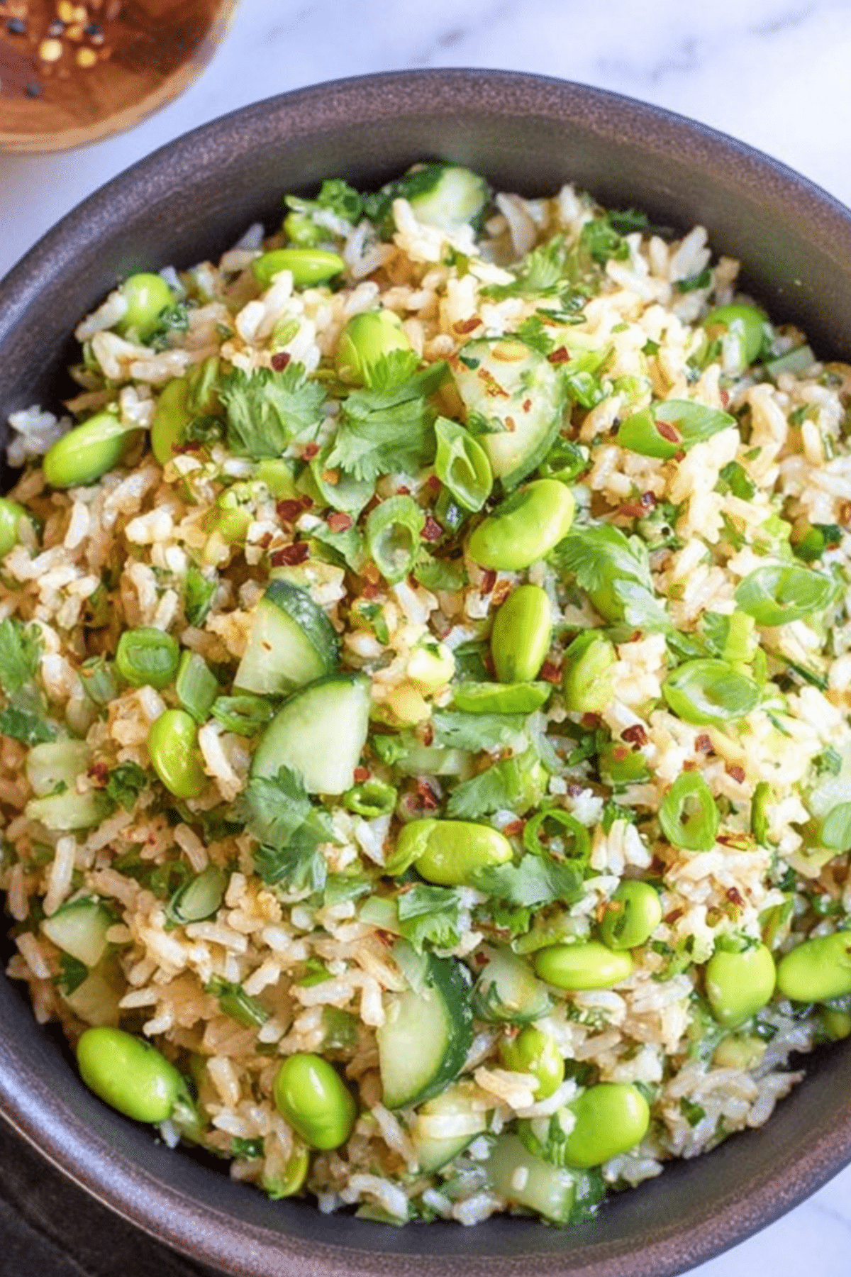 Cucumber Edamame Rice Salad with fresh veggies and plant-based protein