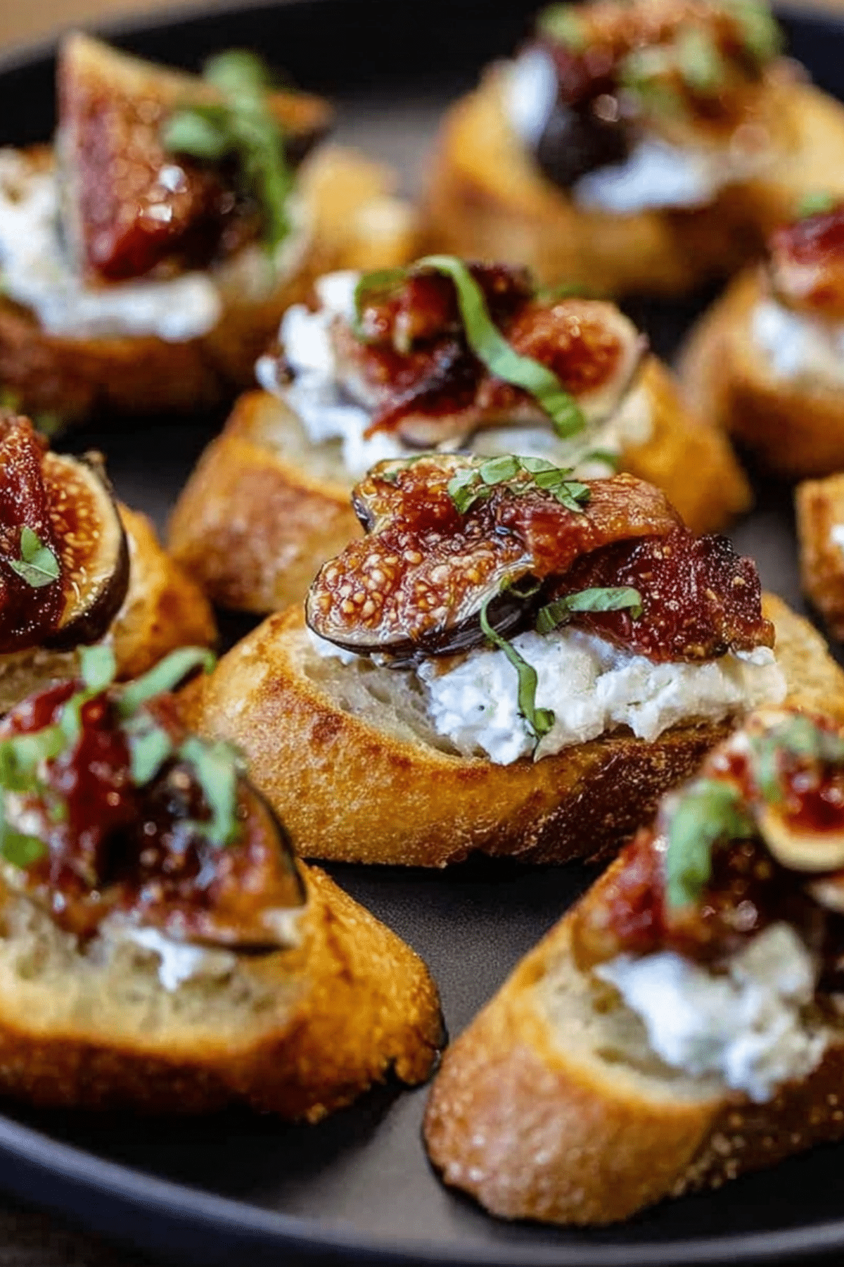 Golden fig bruschetta with burrata, prosciutto, and basil on toasted baguette