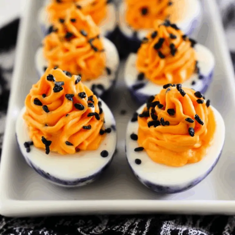 Halloween Deviled Eggs with cracked black shells and orange filling