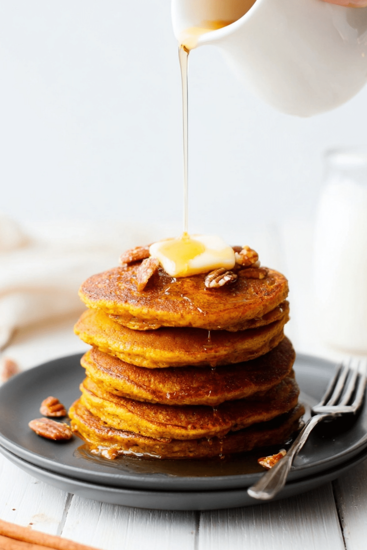 oatmeal pumpkin pancakes served with maple syrup and butter