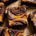 Pumpkin Brownies served on a plate with chocolate chips