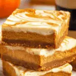 Pumpkin Cheesecake Bars recipe with pumpkin pie and cheesecake swirl
