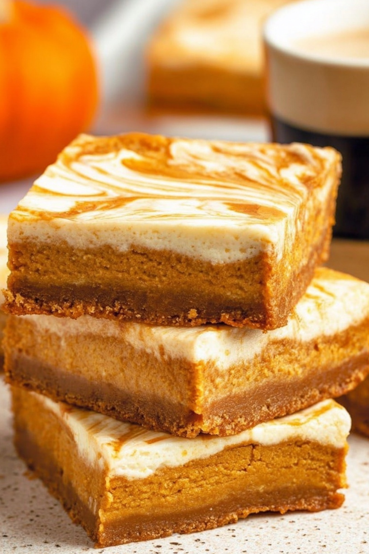 Pumpkin Cheesecake Bars recipe with pumpkin pie and cheesecake swirl