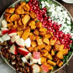 Salad with Butternut Squash and Apple served in a bowl with greens