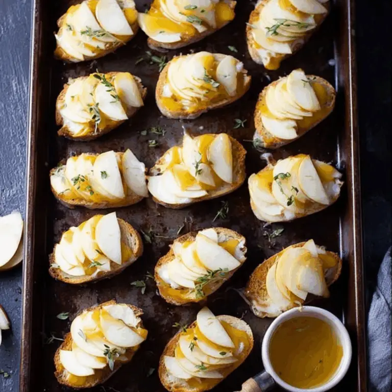 Smoked Gouda & Apple Crostini topped with thyme and honey drizzle