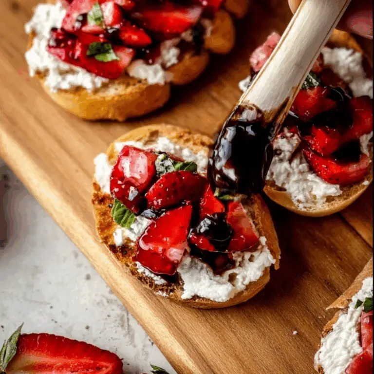 Strawberry Goat Cheese Bruschetta topped with fresh basil and balsamic glaze