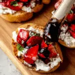 Strawberry Goat Cheese Bruschetta topped with fresh basil and balsamic glaze