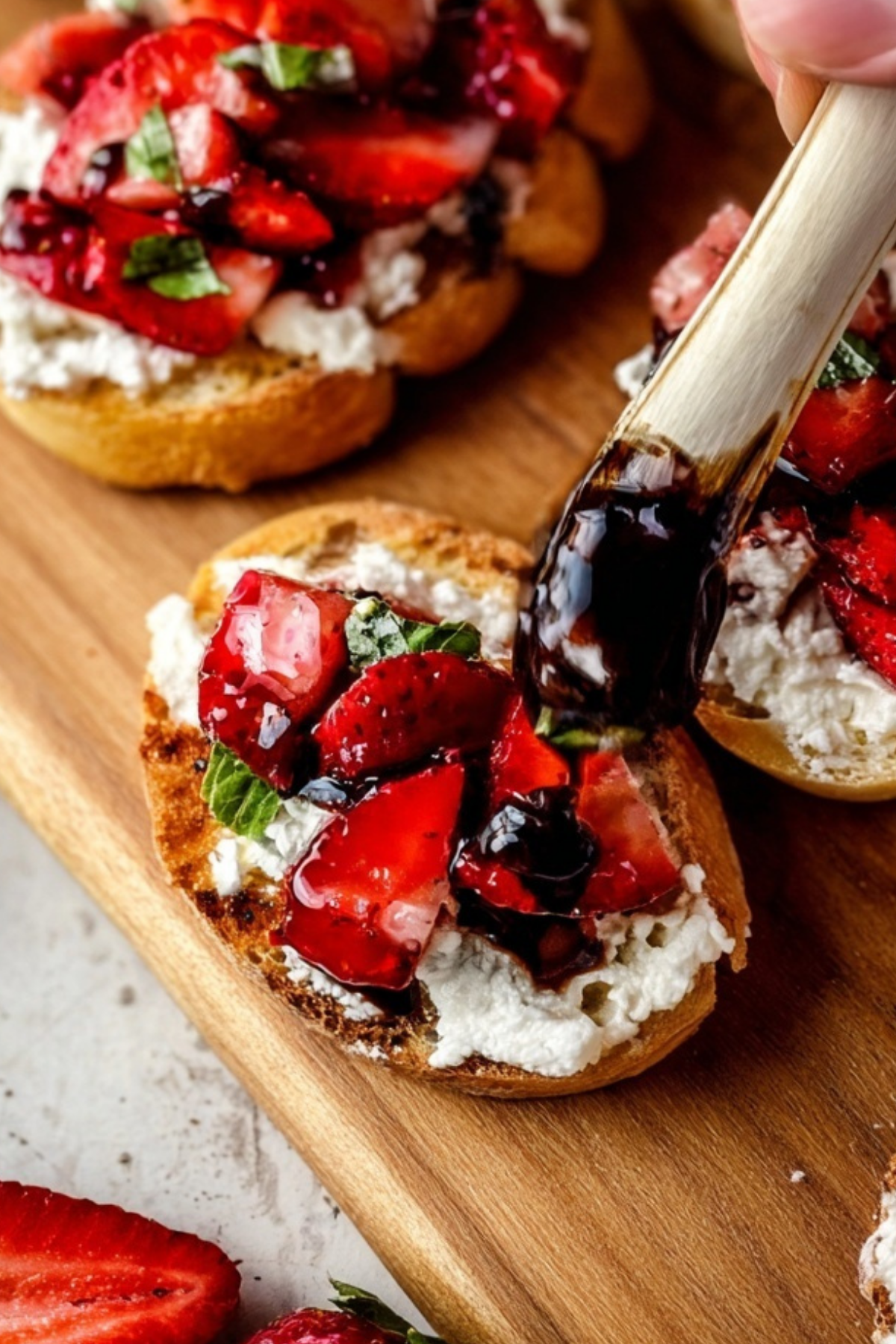 Strawberry Goat Cheese Bruschetta topped with fresh basil and balsamic glaze