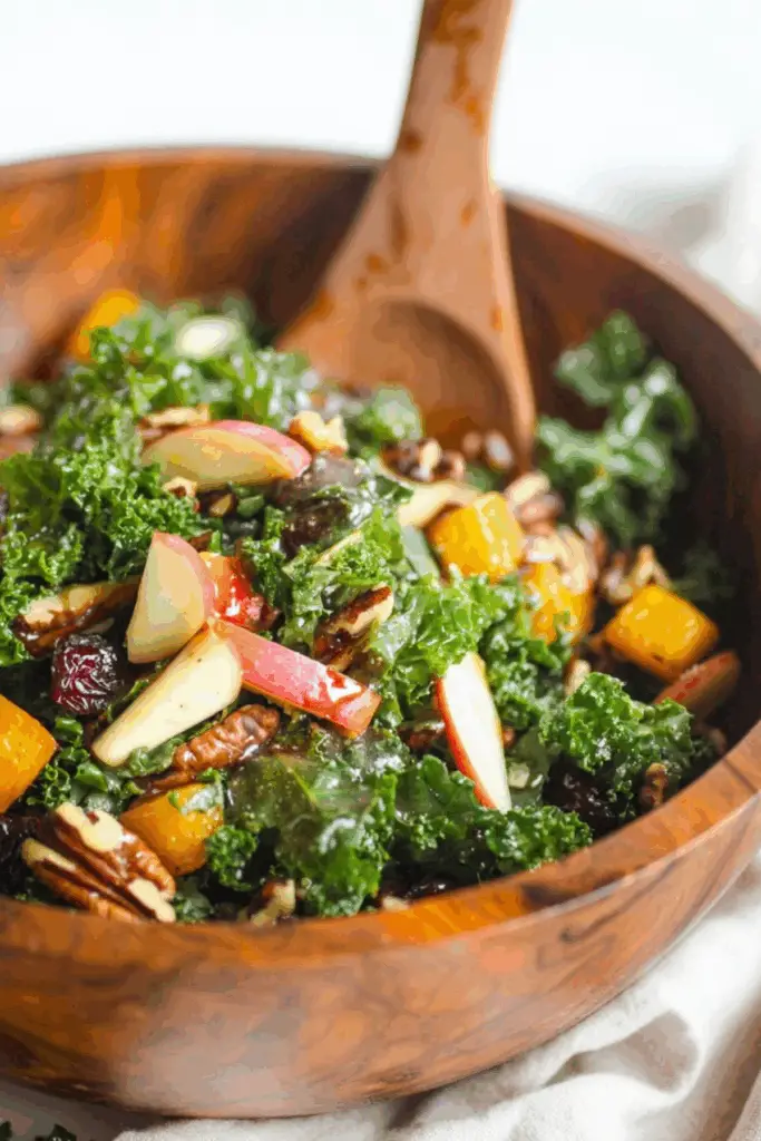 Autumn Kale Salad with Maple Balsamic Vinaigrette topped with squash and apples