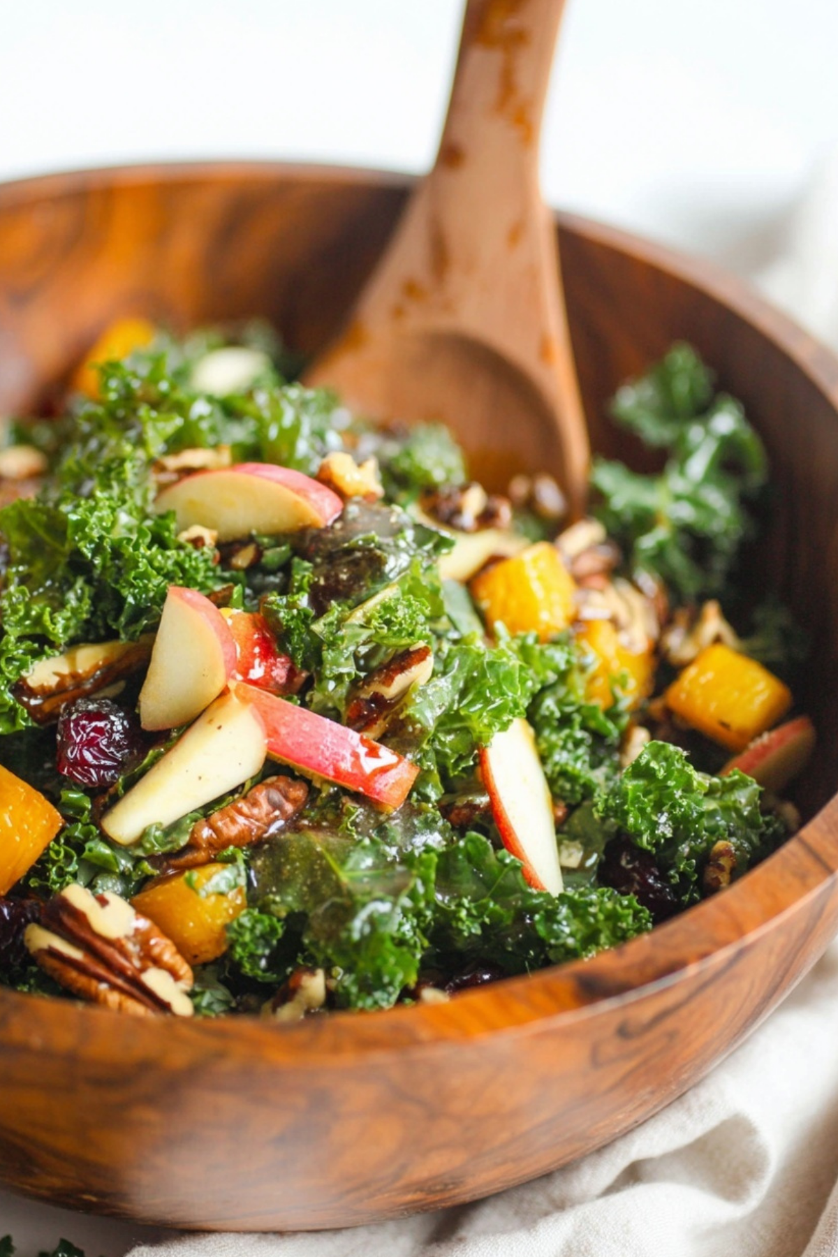Autumn Kale Salad with Maple Balsamic Vinaigrette topped with squash and apples
