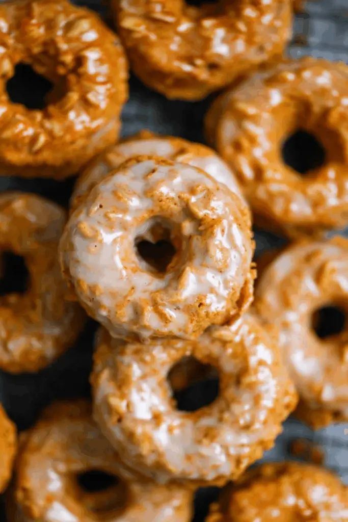 baked pumpkin donuts with maple glaze on cooling rack