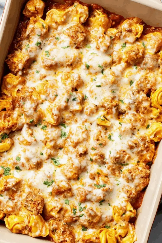Cheesy baked tortellini in casserole dish with marinara and beef