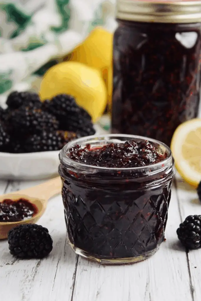 Blackberry Vanilla Bourbon Jam in glass jar with spoon