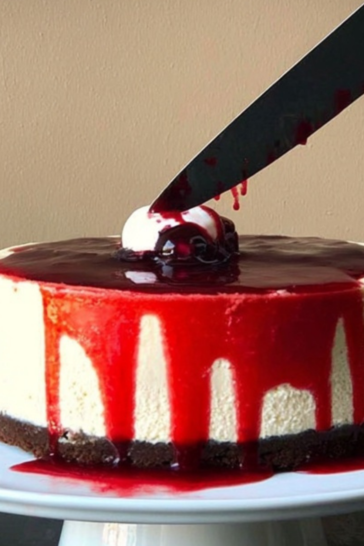 Bloody Good Halloween Cheesecake with chocolate cookie base and red drip effect