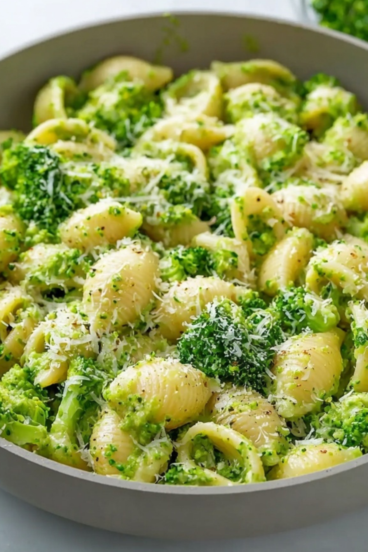 Healthy Broccoli Pasta in white bowl with Parmesan