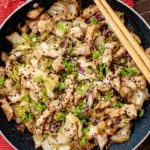 Chicken Cabbage Stir Fry in a skillet with vegetables and chicken strips
