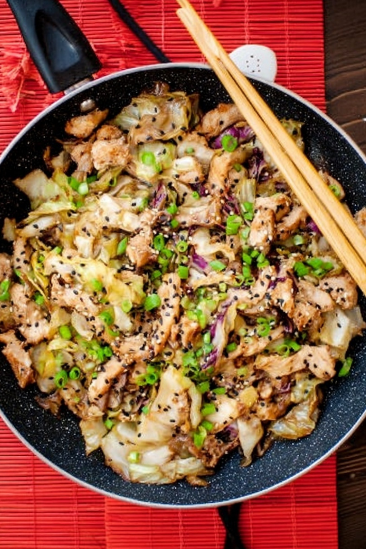 Chicken Cabbage Stir Fry in a skillet with vegetables and chicken strips