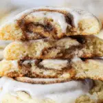 freshly baked cinnamon roll cookies with cream cheese frosting