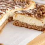 Slice of creamy Coffee Cake Cheesecake with cinnamon crumble topping
