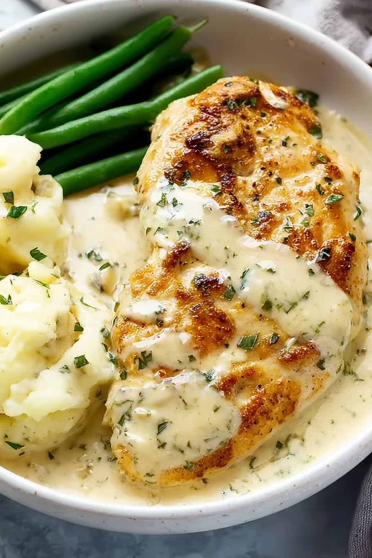 Creamy Ranch Chicken in skillet with sauce and potatoes