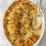 creamy scalloped potatoes in baking dish with golden crispy top
