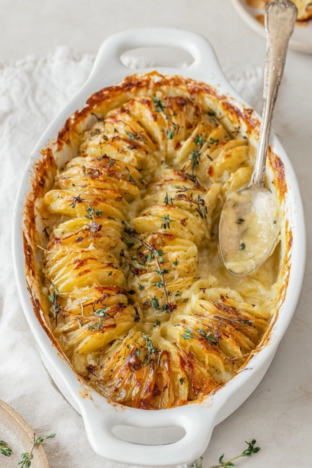 creamy scalloped potatoes in baking dish with golden crispy top