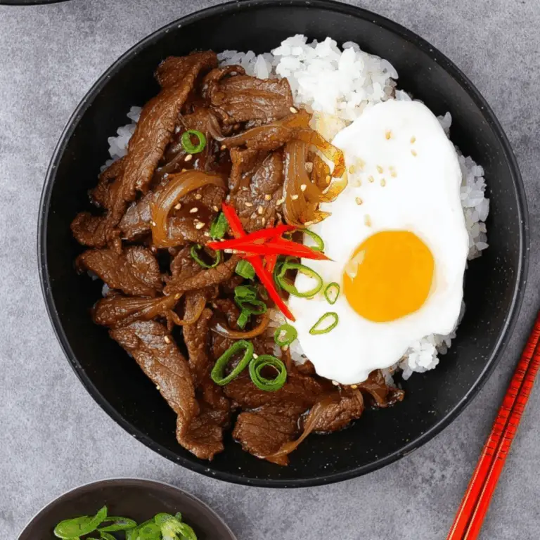 Gyudon Japanese beef bowl with rice, onions, and poached egg