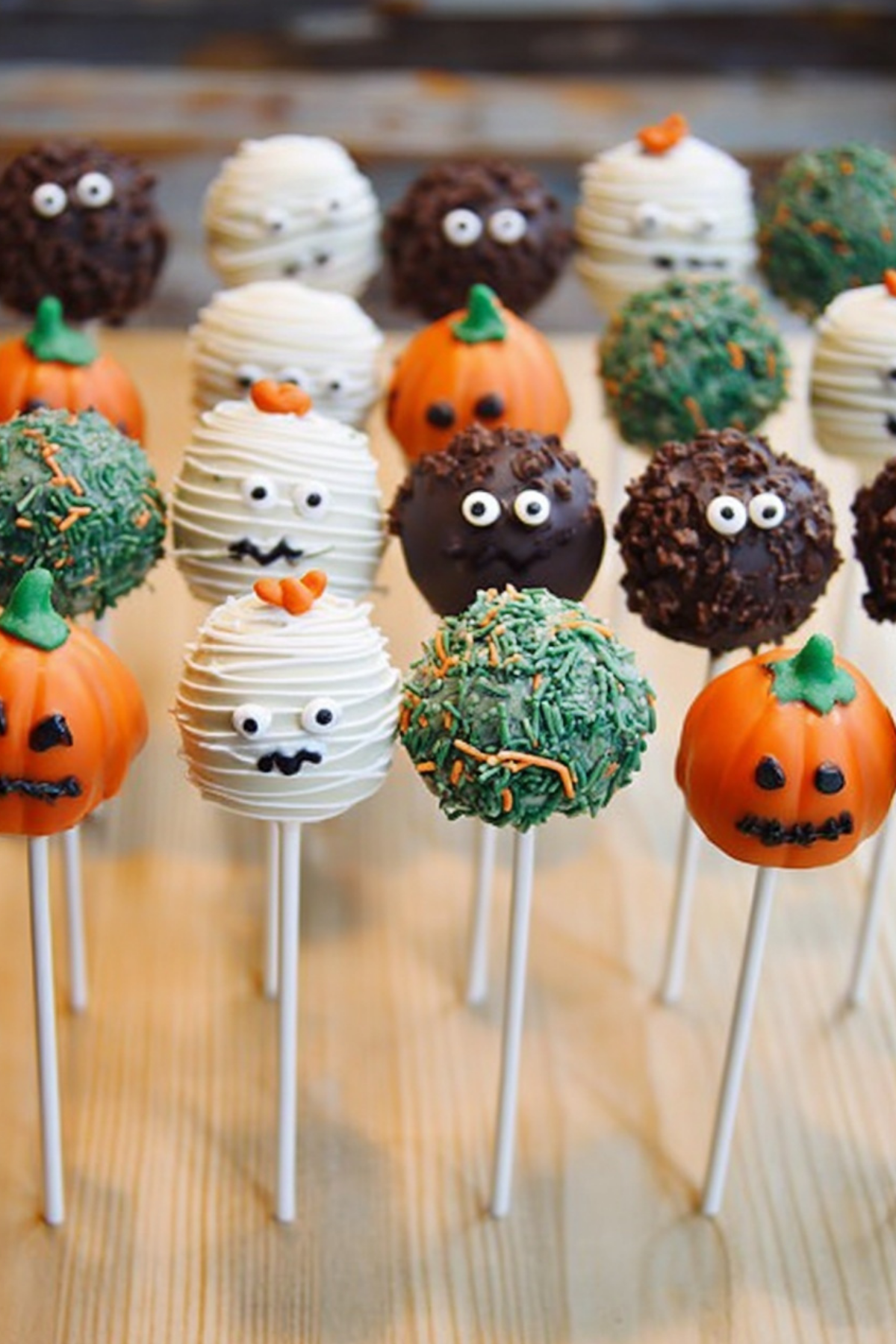 Halloween Cake Pops decorated with candy eyes and Halloween-themed designs.