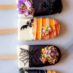 Halloween Cakesicles decorated with sprinkles and chocolate coating