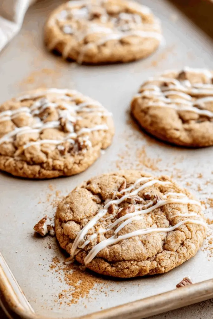 Freshly baked maple pecan cookies on a cooling rack