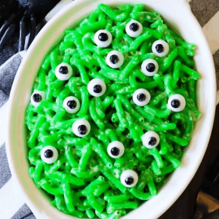 Monster Mac and Cheese Halloween recipe with green pasta and candy eyeballs