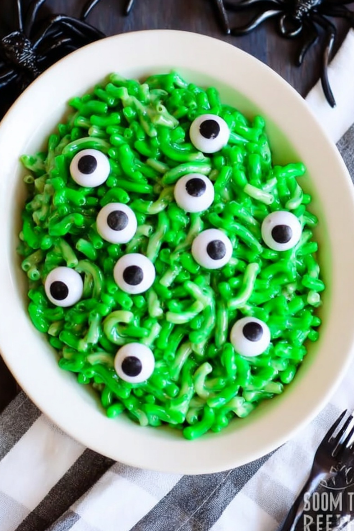 Monster Mac and Cheese Halloween recipe with green pasta and candy eyeballs