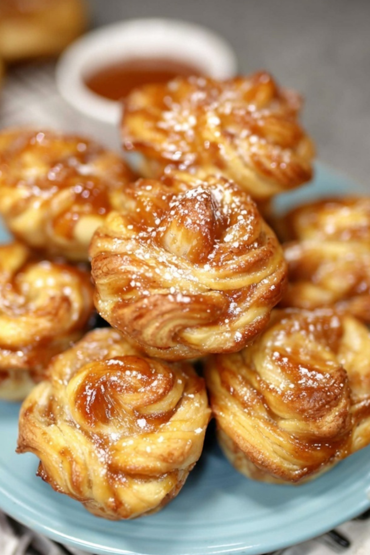 Peach Pie Cruffins with powdered sugar glaze and flaky layers