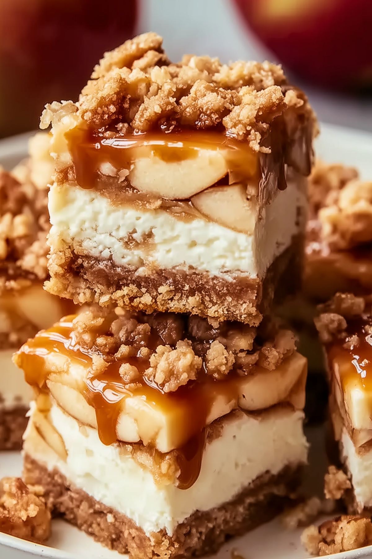 Caramel Apple Cheesecake Bars topped with gooey caramel and cinnamon apples
