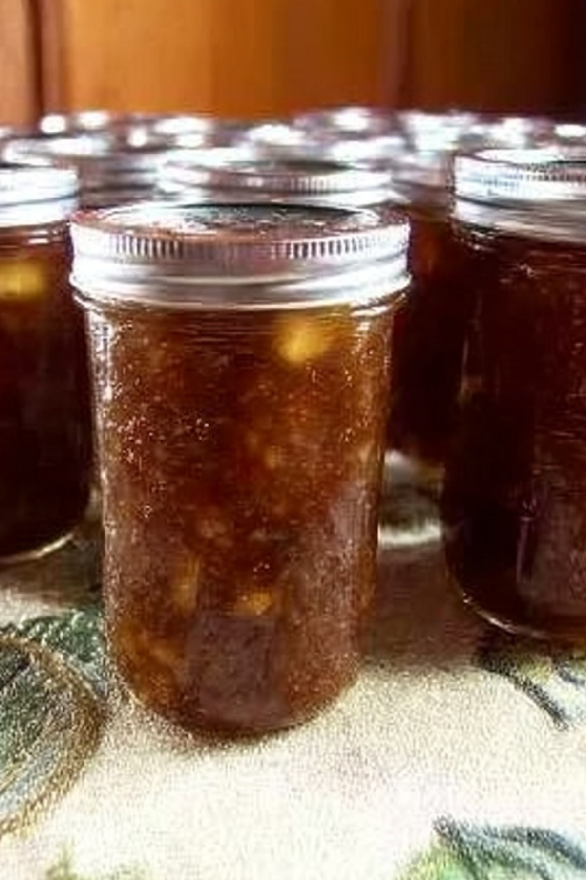 Homemade Caramel Apple Jam in glass jars with cinnamon sticks