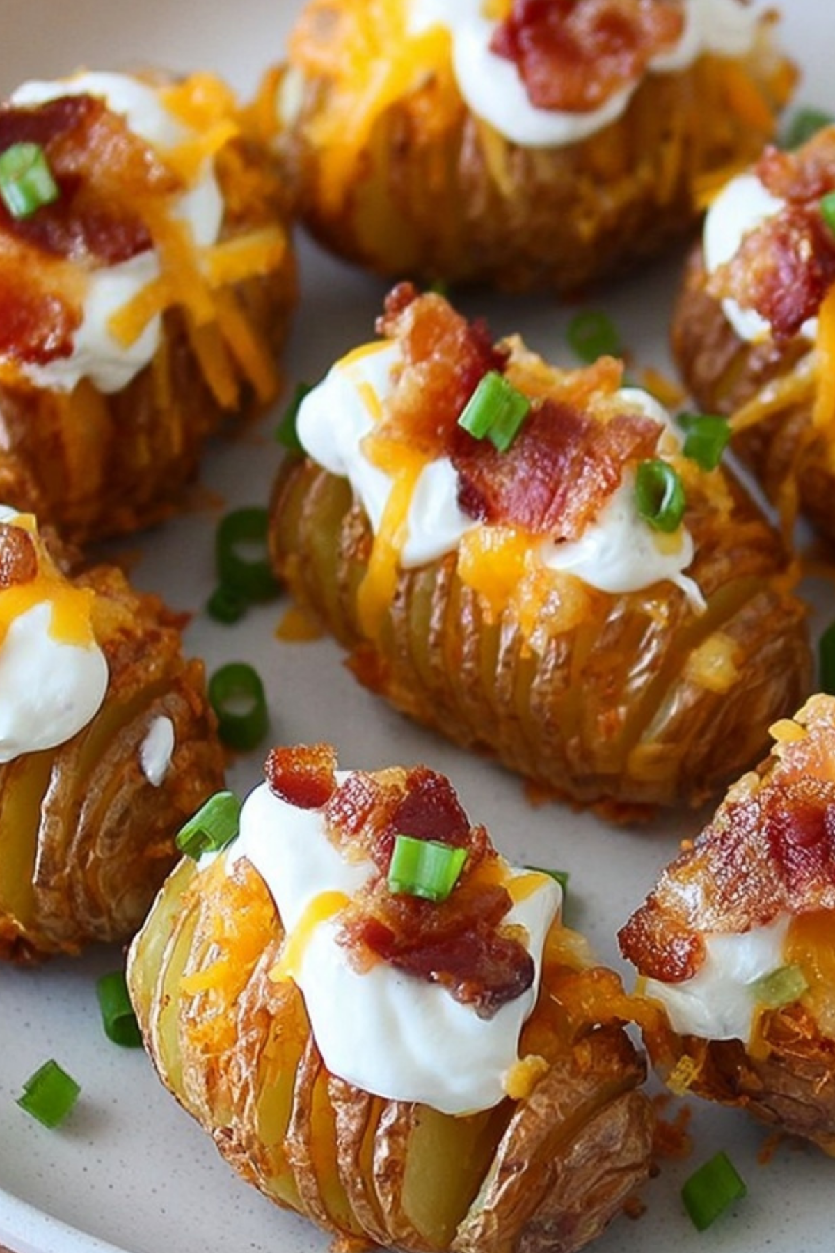 Crispy Loaded Hasselback Potato Bites with melted cheese and bacon