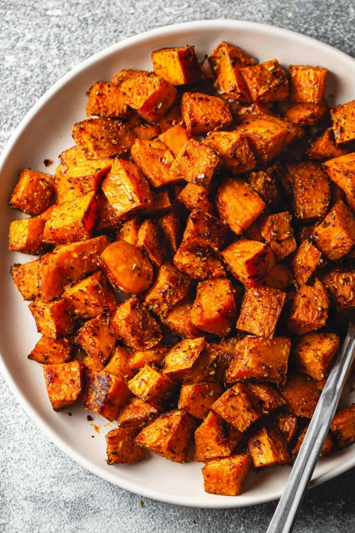 crispy roasted sweet potatoes in a baking dish
