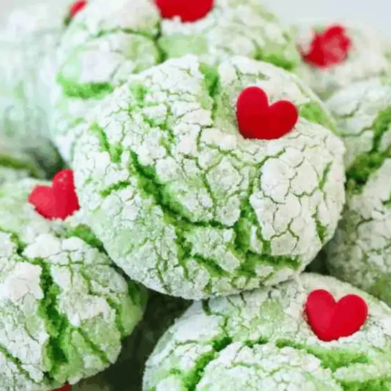 Grinch Cookie with heart sprinkles on a plate