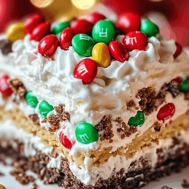 Christmas Dessert Lasagna with layers of Oreo crust, cheesecake, and pudding topped with festive sprinkles.